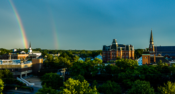 View of downtown Peabody, rainbow, and two churches