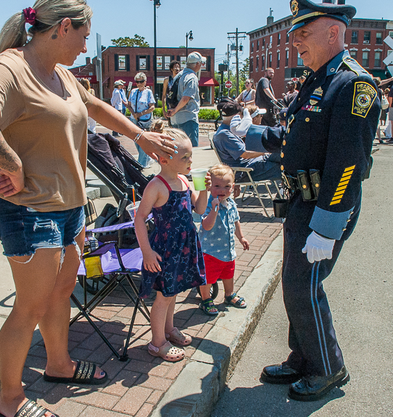 Mother, children, and police officer at parade