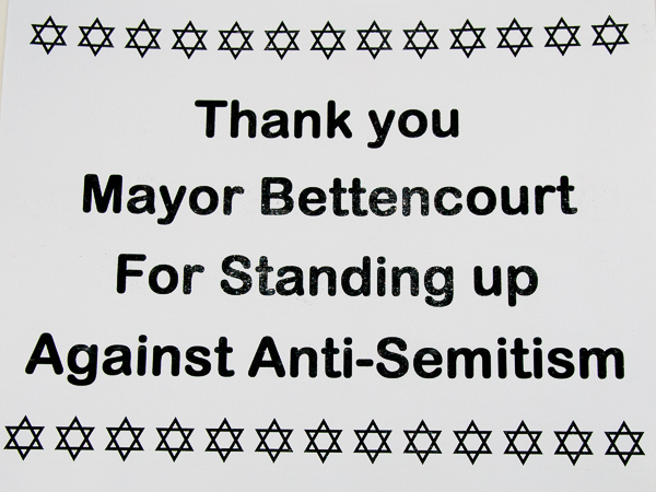 Sign displayed at interfaith gathering against antisemitism