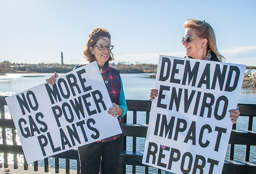 Rep Sally Kerans and Sen Joan Lovely hold signs at Danversport Bridge