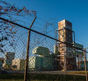 Metal tower behind fence, electric generator