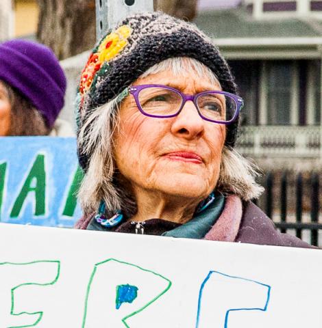 Cathy Marie Michael, holding sign made by her grandchildren