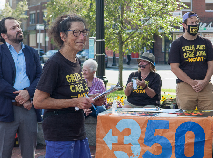 Judith Black and demonstrators listen to presentation