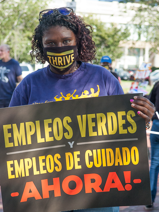 Woman displays sign in Spanish