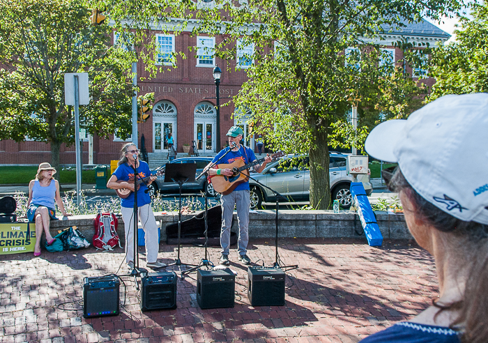 Two musicians lead crowd in singing