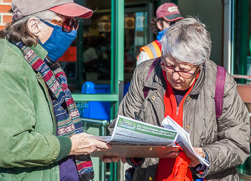 Patricia Sullivan collects signature on petition from shopper at Market Basket