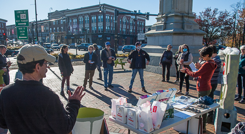 Volunteers assemble to get instructions on signature drive