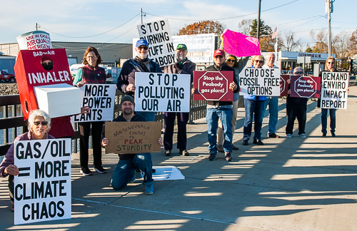 Advocates display signs at Danversport Bridge, between Peabody and Danvers