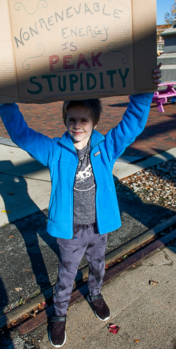 Young man holding sign joins standout at Peabody Square