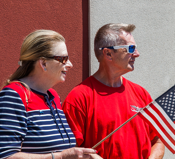 Man and woman watch Memorial Day parade