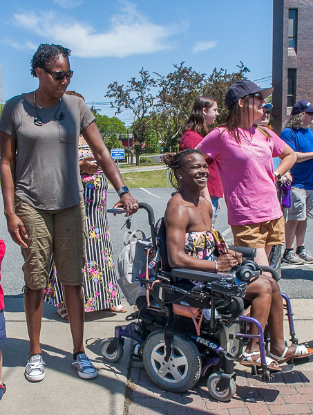 Young woman in wheelchair with companions