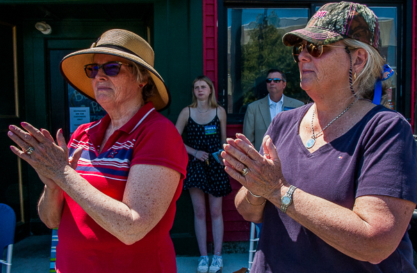 Two women applaud passing Memorial Day parade