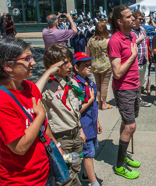 Young people salute during playing of national anthem