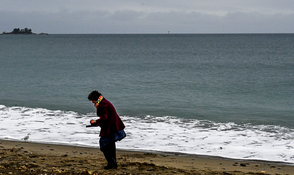 Reverend Kendra Ford gathers stones on Devereux Beach