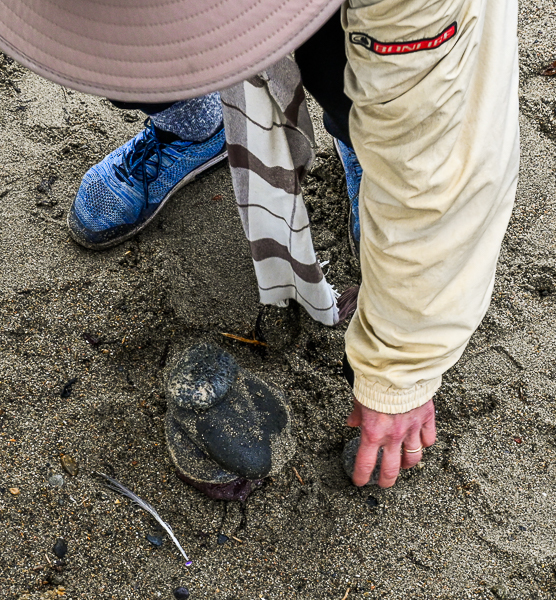 Judith Black adds a stone to the memorial