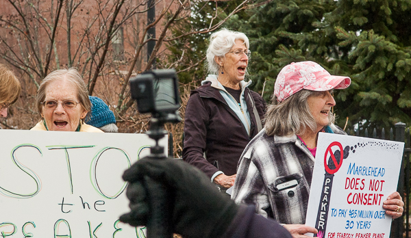 Holly Janes, right, holding sign