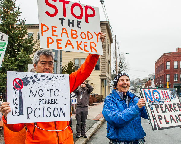 Nathan Phillips & Sue Donaldson hold signs for passing cars