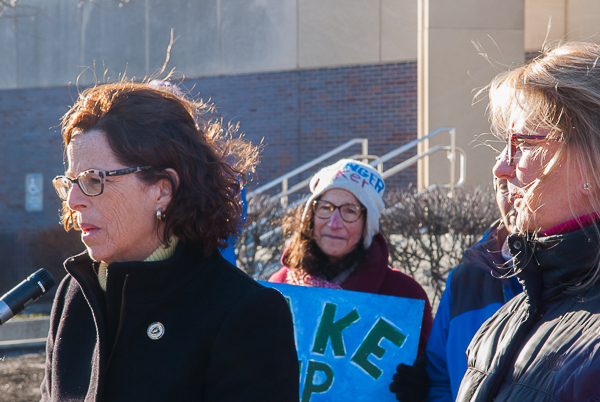 Representative Sally Kerans addresses demonstrators, SenatorJoan Lovely stands beside her; Judith Black in background