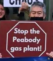 Nathan Phillips holds sign at demonstration against the Peabody Peaker