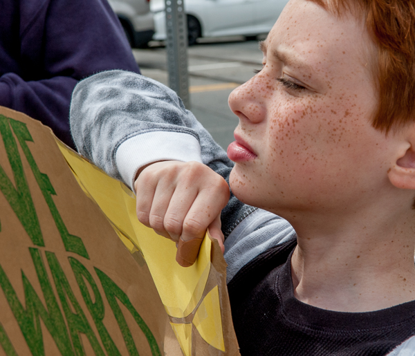 Young person at standout against peaker plant