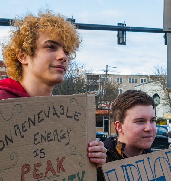 Leo and Ryan, Juniors at Peabody Memorial High, hold signs