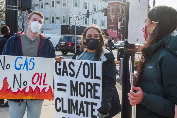 Demonstrators display signs at standout